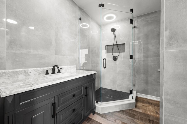 1170 Gulf Blvd Unit 2101, Clearwater Beach, FL 33767 - full bath featuring wood finished floors, a shower stall, and vanity