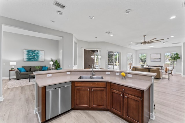 10517 Palm Cove Ave, Tampa, FL 33647 - kitchen with visible vents, stainless steel dishwasher, a sink, light countertops, and open floor plan