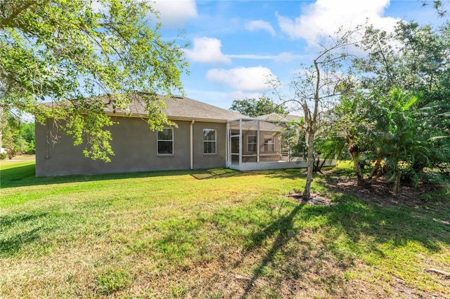 10517 Palm Cove Ave, Tampa, FL 33647 - rear view of property with stucco siding and a yard