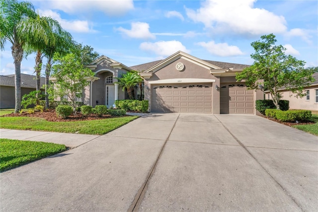 10517 Palm Cove Ave, Tampa, FL 33647 - view of front of house with concrete driveway, an attached garage, and stucco siding