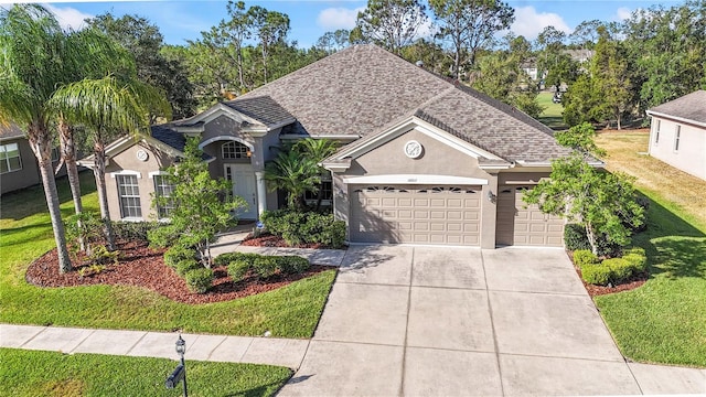 10517 Palm Cove Ave, Tampa, FL 33647 - ranch-style house featuring roof with shingles, a front lawn, concrete driveway, an attached garage, and stucco siding