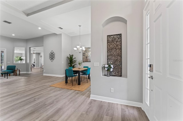 10517 Palm Cove Ave, Tampa, FL 33647 - entrance foyer featuring baseboards, visible vents, and light wood finished floors