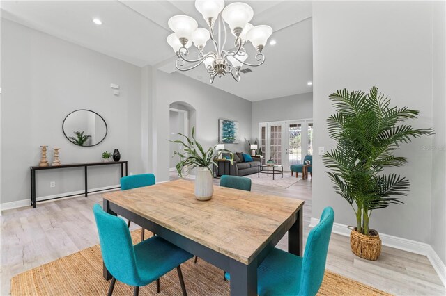 10517 Palm Cove Ave, Tampa, FL 33647 - dining area featuring arched walkways, light wood-type flooring, baseboards, a chandelier, and recessed lighting