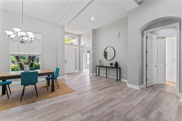 10517 Palm Cove Ave, Tampa, FL 33647 - dining space featuring a notable chandelier, light wood-style floors, arched walkways, recessed lighting, and baseboards