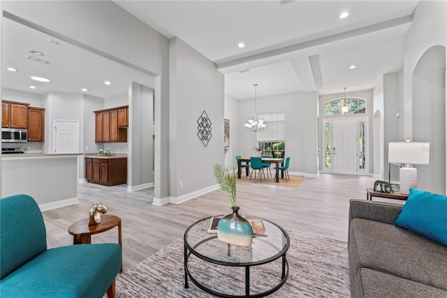 10517 Palm Cove Ave, Tampa, FL 33647 - living area featuring recessed lighting, baseboards, light wood-type flooring, and a notable chandelier