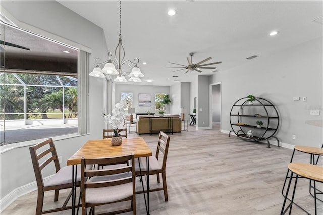 10517 Palm Cove Ave, Tampa, FL 33647 - dining space featuring light wood-style floors, baseboards, ceiling fan with notable chandelier, and recessed lighting