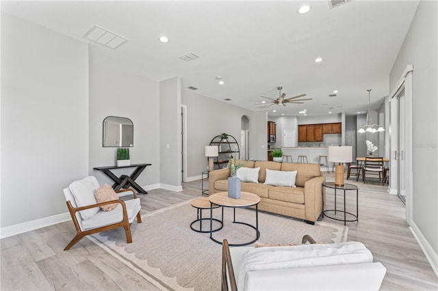 10517 Palm Cove Ave, Tampa, FL 33647 - living room with recessed lighting, arched walkways, visible vents, and light wood finished floors