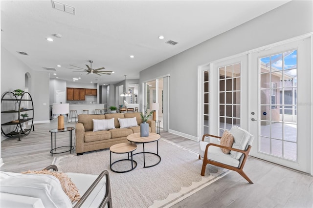 10517 Palm Cove Ave, Tampa, FL 33647 - living room featuring recessed lighting, baseboards, light wood-type flooring, and visible vents