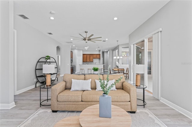 10517 Palm Cove Ave, Tampa, FL 33647 - living room featuring baseboards, a ceiling fan, and light wood finished floors