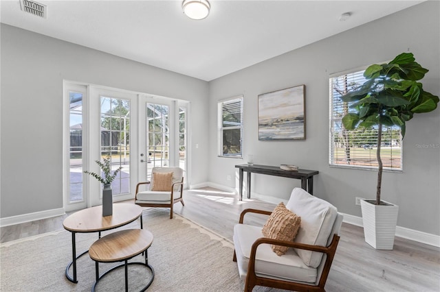 10517 Palm Cove Ave, Tampa, FL 33647 - sitting room featuring visible vents, baseboards, wood finished floors, and french doors