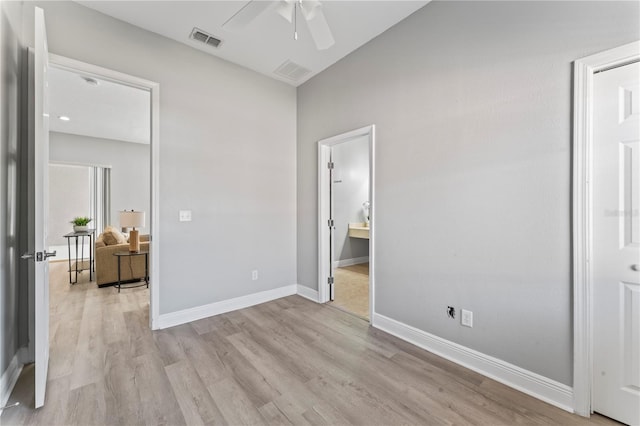 10517 Palm Cove Ave, Tampa, FL 33647 - bedroom with ensuite bath, baseboards, visible vents, and light wood-type flooring