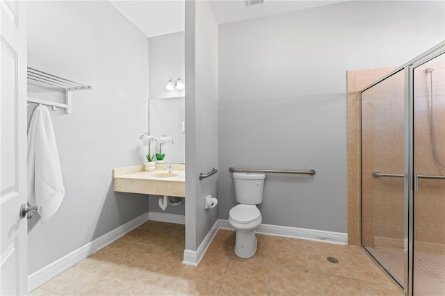 10517 Palm Cove Ave, Tampa, FL 33647 - bathroom featuring toilet, baseboards, tile patterned flooring, and a stall shower