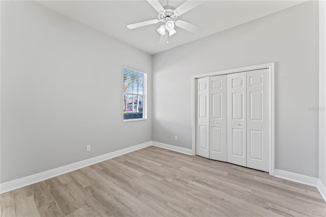 10517 Palm Cove Ave, Tampa, FL 33647 - unfurnished bedroom featuring baseboards, a ceiling fan, light wood finished floors, and a closet