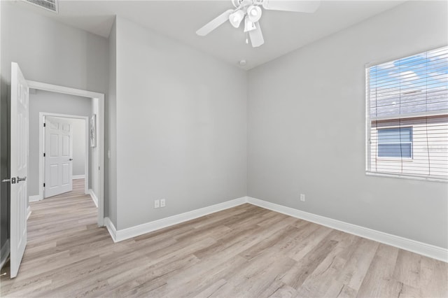 10517 Palm Cove Ave, Tampa, FL 33647 - empty room featuring a ceiling fan, baseboards, plenty of natural light, and light wood-style floors