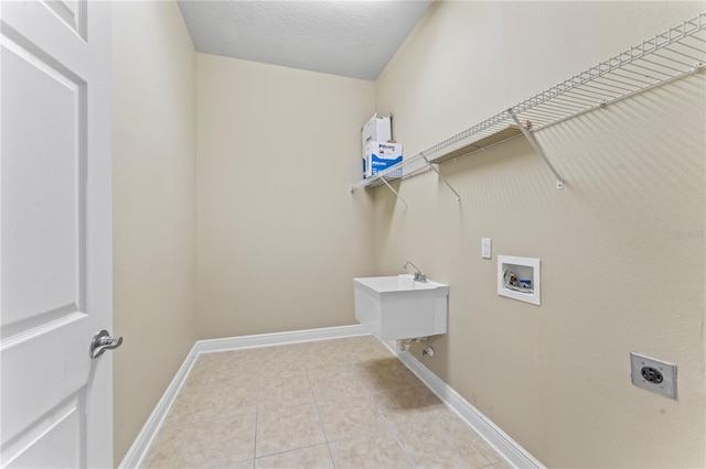 10517 Palm Cove Ave, Tampa, FL 33647 - washroom with laundry area, baseboards, hookup for a washing machine, electric dryer hookup, and light tile patterned floors