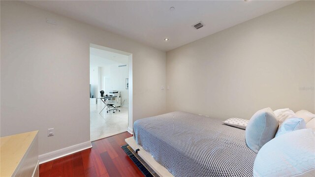 bedroom with visible vents, recessed lighting, baseboards, and wood finished floors