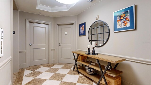 interior space featuring ornamental molding and a tray ceiling