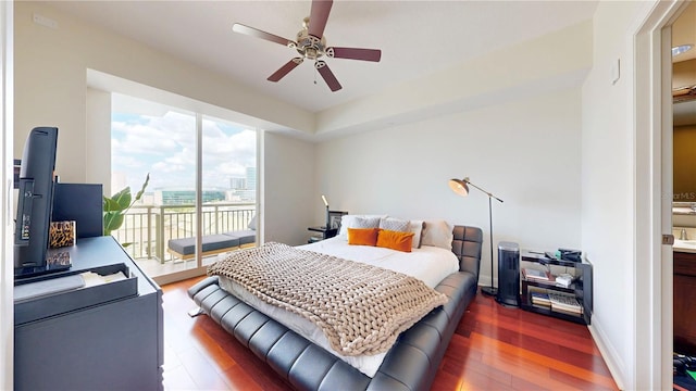 bedroom with baseboards, a ceiling fan, wood finished floors, and access to exterior