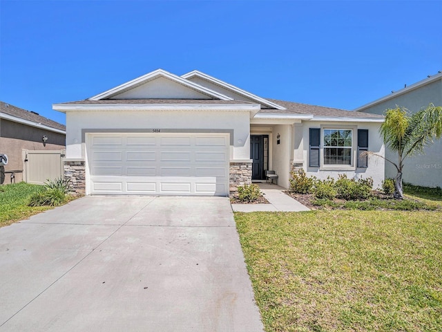 5464 Flint Hills Dr, Wimauma, FL 33598 - view of front of property with driveway, a front yard, an attached garage, stone siding, and stucco siding