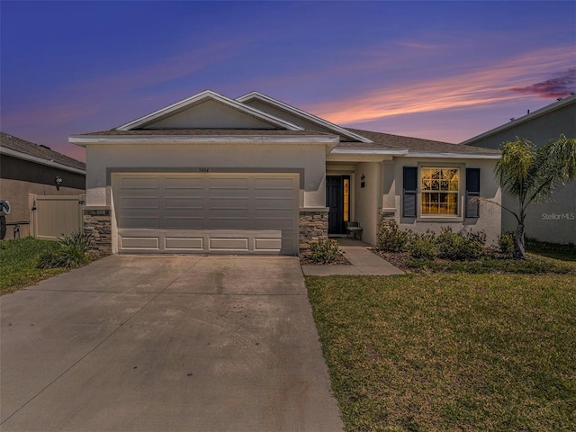 5464 Flint Hills Dr, Wimauma, FL 33598 - ranch-style house featuring a garage, stone siding, stucco siding, concrete driveway, and a lawn