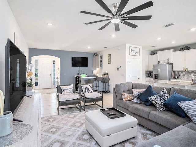 5464 Flint Hills Dr, Wimauma, FL 33598 - living area with arched walkways, ceiling fan, recessed lighting, and visible vents