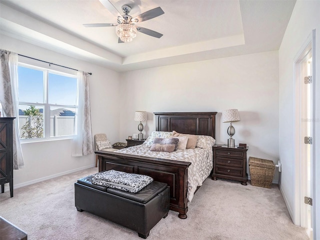 5464 Flint Hills Dr, Wimauma, FL 33598 - bedroom with a ceiling fan, baseboards, light carpet, and a raised ceiling
