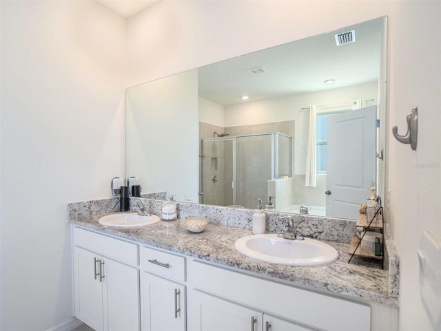 5464 Flint Hills Dr, Wimauma, FL 33598 - full bath with visible vents, a sink, a stall shower, and double vanity