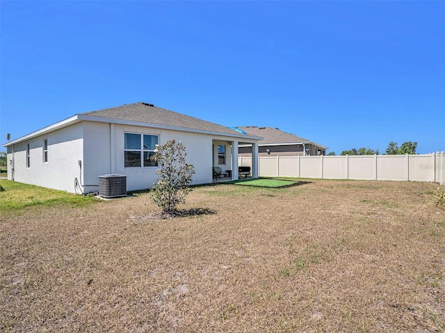 5464 Flint Hills Dr, Wimauma, FL 33598 - back of property featuring fence, a lawn, stucco siding, and cooling unit