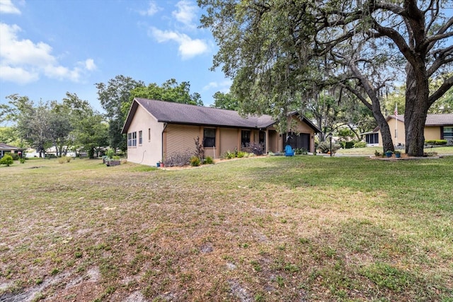 7120 N Croton Pt, Hernando, FL 34442 - back of house featuring a lawn and a garage