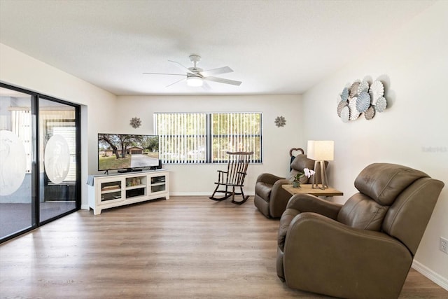 7120 N Croton Pt, Hernando, FL 34442 - living room featuring baseboards, ceiling fan, and wood finished floors