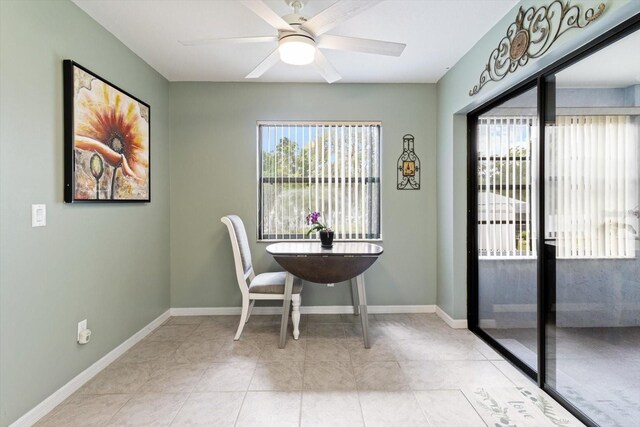 7120 N Croton Pt, Hernando, FL 34442 - dining area with light tile patterned floors, baseboards, a ceiling fan, and a wealth of natural light
