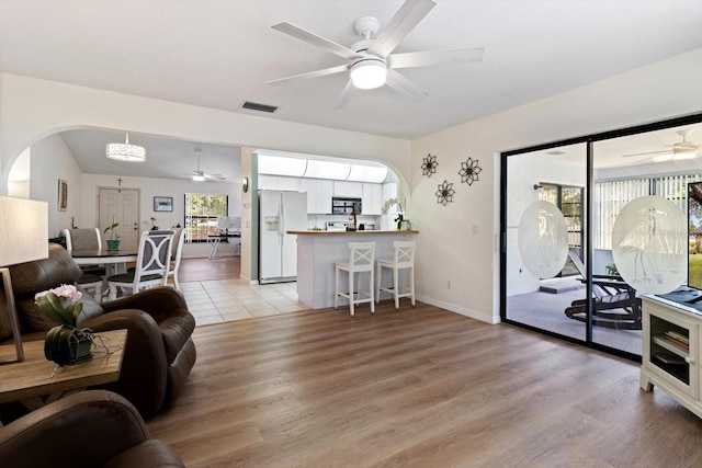 7120 N Croton Pt, Hernando, FL 34442 - living room with arched walkways, a ceiling fan, light wood finished floors, and visible vents