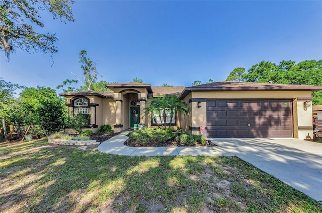 12923 Colony Rd, Hudson, FL 34669 - view of front of property with an attached garage, stucco siding, driveway, and a front yard