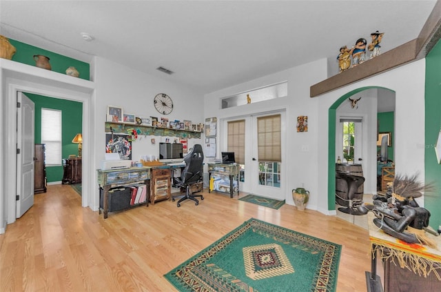 12923 Colony Rd, Hudson, FL 34669 - home office with arched walkways, visible vents, french doors, and wood finished floors