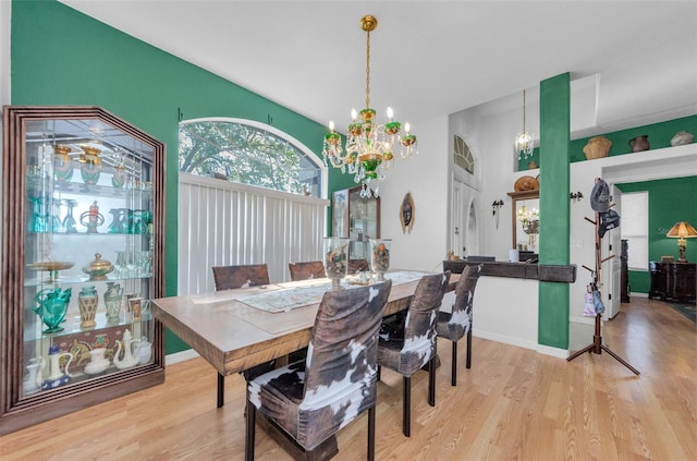 12923 Colony Rd, Hudson, FL 34669 - dining room with baseboards, a chandelier, and light wood-style floors