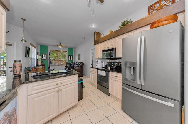 12923 Colony Rd, Hudson, FL 34669 - kitchen featuring a ceiling fan, dark stone countertops, light tile patterned flooring, and stainless steel appliances