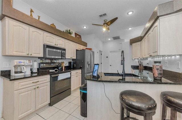 12923 Colony Rd, Hudson, FL 34669 - kitchen featuring appliances with stainless steel finishes, a sink, dark stone countertops, a peninsula, and visible vents