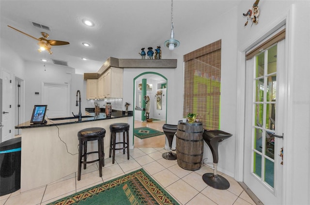 12923 Colony Rd, Hudson, FL 34669 - kitchen featuring a breakfast bar area, dark countertops, visible vents, and a sink