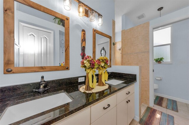 12923 Colony Rd, Hudson, FL 34669 - full bathroom with double vanity, toilet, visible vents, and a sink