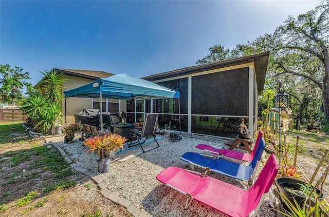 12923 Colony Rd, Hudson, FL 34669 - back of property featuring a sunroom and a patio area