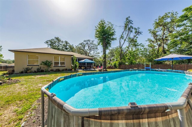 12923 Colony Rd, Hudson, FL 34669 - view of swimming pool featuring fence, a fenced in pool, and a yard