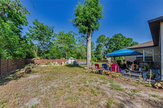 12923 Colony Rd, Hudson, FL 34669 - view of yard with a storage unit, a fenced backyard, and an outbuilding
