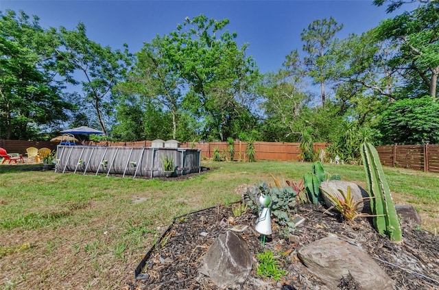 12923 Colony Rd, Hudson, FL 34669 - view of yard featuring a fenced in pool and a fenced backyard