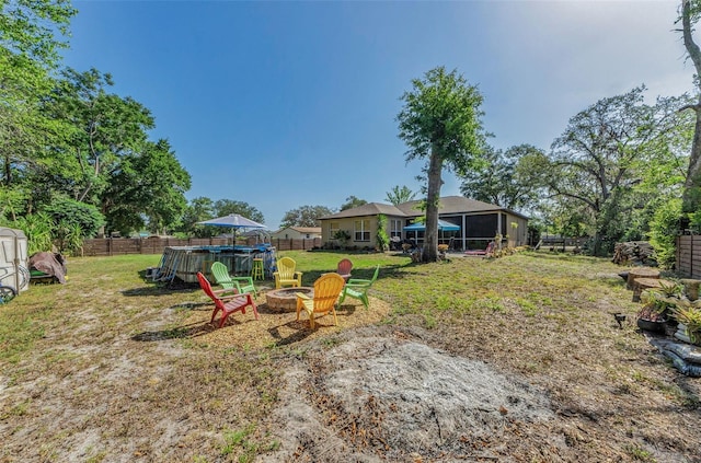 12923 Colony Rd, Hudson, FL 34669 - view of yard featuring a hot tub, a fire pit, and a fenced backyard