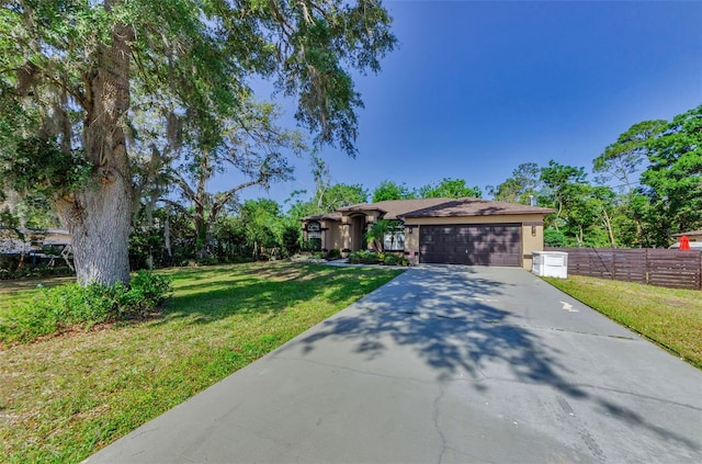 12923 Colony Rd, Hudson, FL 34669 - ranch-style home with an attached garage, fence, a front yard, and concrete driveway