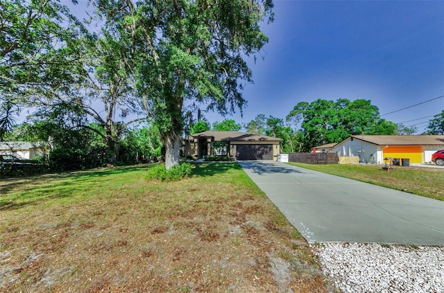 12923 Colony Rd, Hudson, FL 34669 - ranch-style house with an attached garage, a front lawn, fence, and concrete driveway