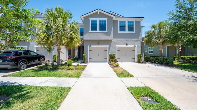 view of front of home featuring a garage, stucco siding, and concrete driveway