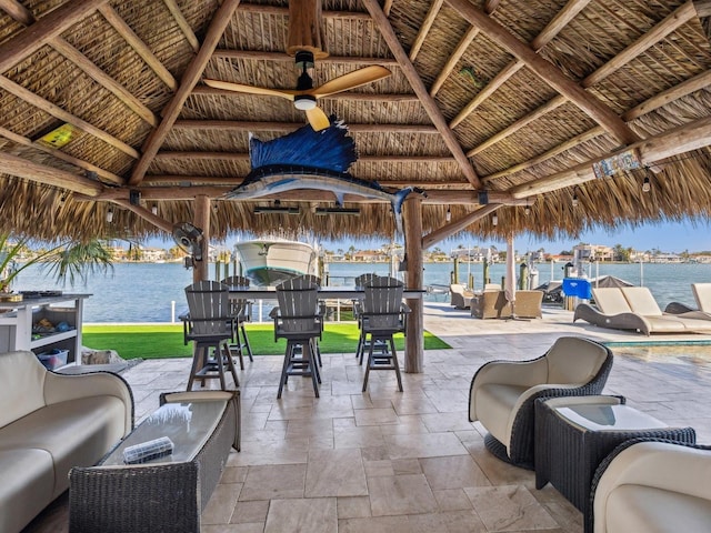 view of patio with a water view, a gazebo, and outdoor lounge area