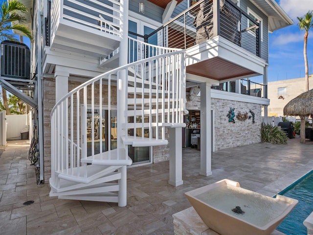 view of patio / terrace with central AC unit and stairway