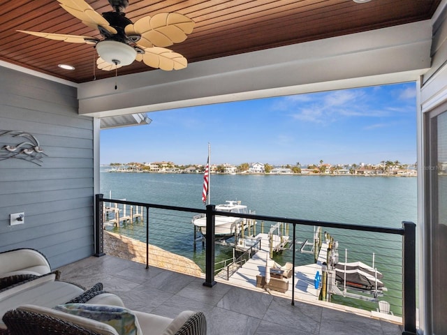 balcony featuring a ceiling fan and a water view